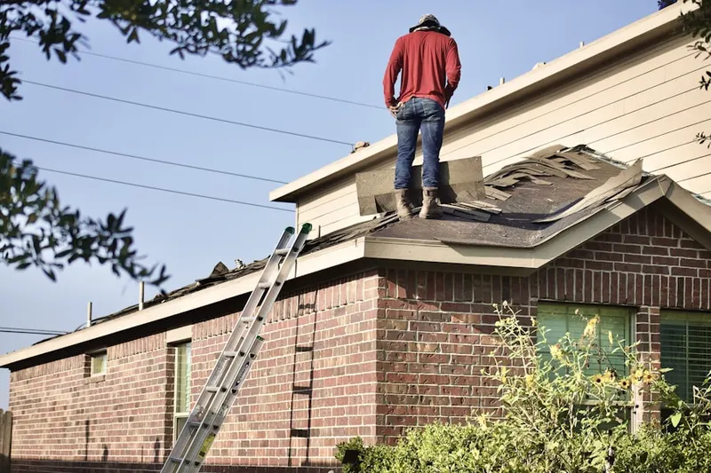 Professional roofer working on a residential roof in Des Moines